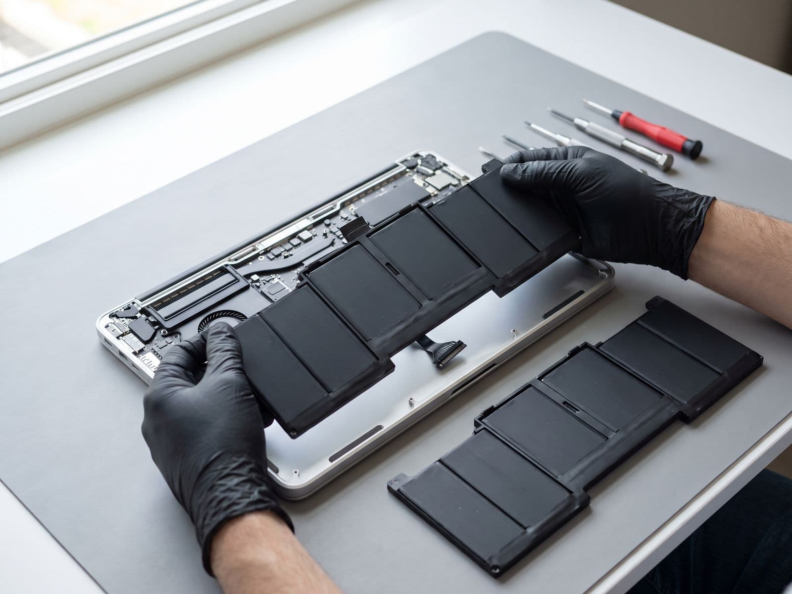 Laptop battery pack being replaced